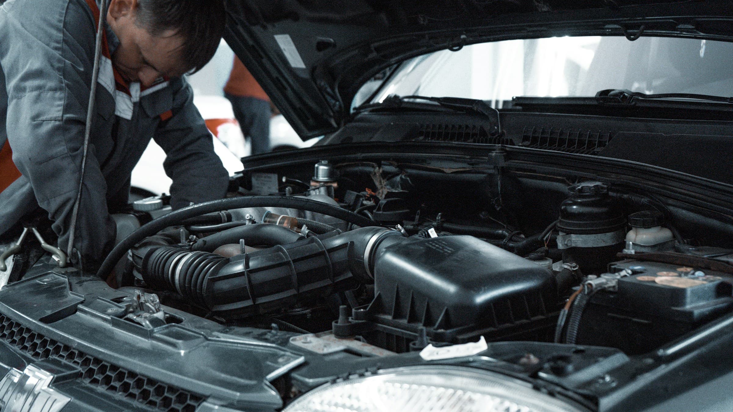 Technician working in an engine bay